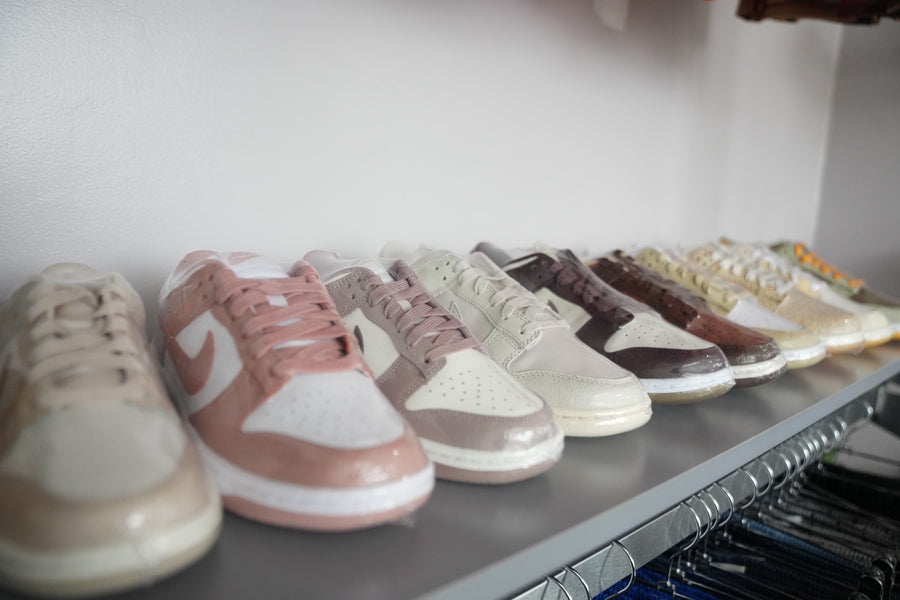 Row of tonal Nike Dunks on a shelf